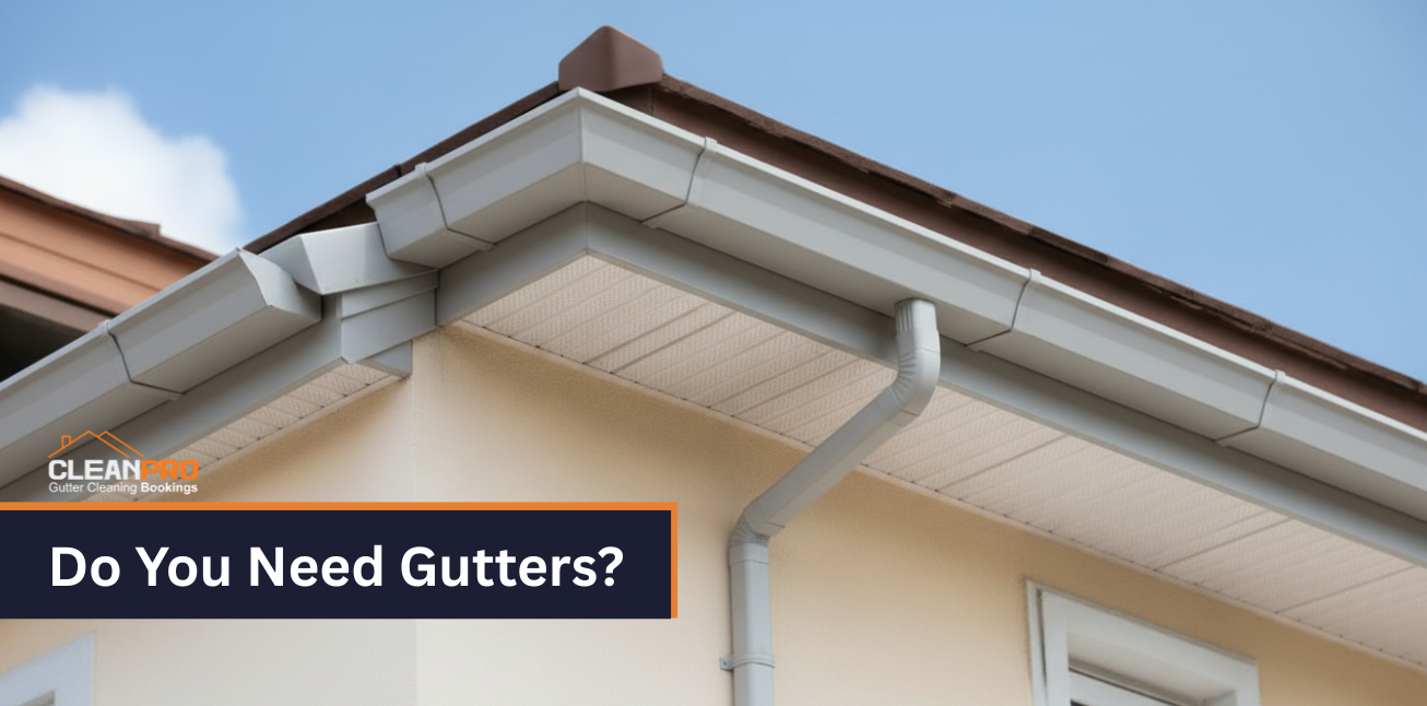 Close-up view of a home’s roofline with clean white gutters and downspouts, showcasing proper gutter installation for water drainage protection.