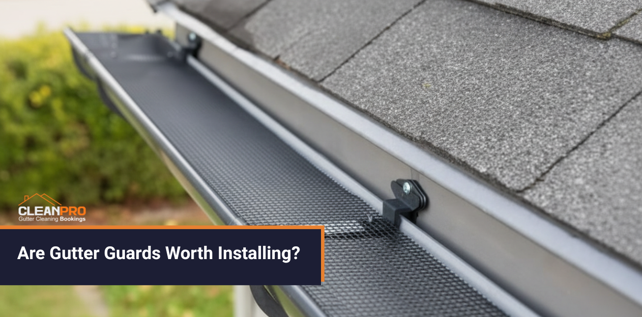 Close-up of a roof with a mesh gutter guard installed, showing how gutter guards prevent leaves and debris from clogging gutters.